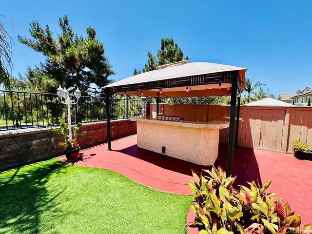1670 Hillsborough St, Chula Vista, CA 91913 - fenced backyard featuring a gazebo, an outdoor kitchen, and a patio
