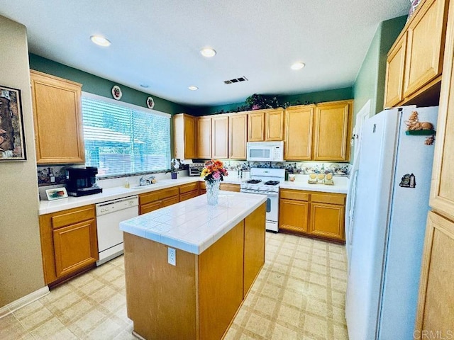 1670 Hillsborough St, Chula Vista, CA 91913 - kitchen featuring white appliances, light flooring, a center island, and recessed lighting