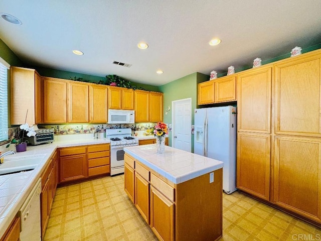 1670 Hillsborough St, Chula Vista, CA 91913 - kitchen with white appliances, tile countertops, light flooring, a center island, and recessed lighting