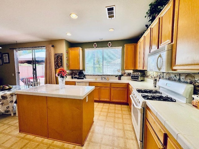 1670 Hillsborough St, Chula Vista, CA 91913 - kitchen with white appliances, tile countertops, plenty of natural light, light flooring, and recessed lighting