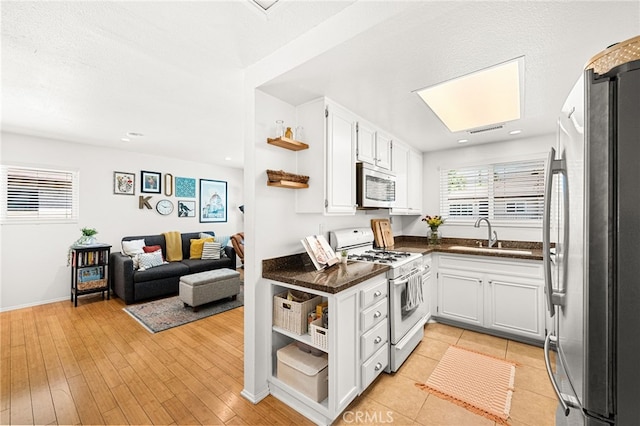 1105 W Calle De La Luna Unit 4, Azusa, CA 91702 - kitchen with freestanding refrigerator, white gas range, open shelves, open floor plan, and recessed lighting