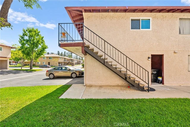 1105 W Calle De La Luna Unit 4, Azusa, CA 91702 - view of home's exterior featuring stairway, a lawn, and stucco siding