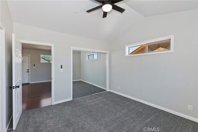 2217 Juniper Ln, Big Bear City, CA 92314 - unfurnished bedroom featuring dark carpet, vaulted ceiling, a closet, and a ceiling fan
