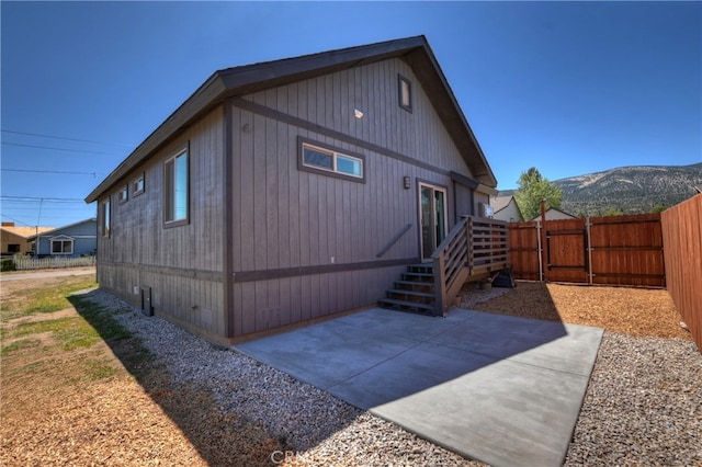 2217 Juniper Ln, Big Bear City, CA 92314 - view of side of home with a gate, a patio area, and a mountain view