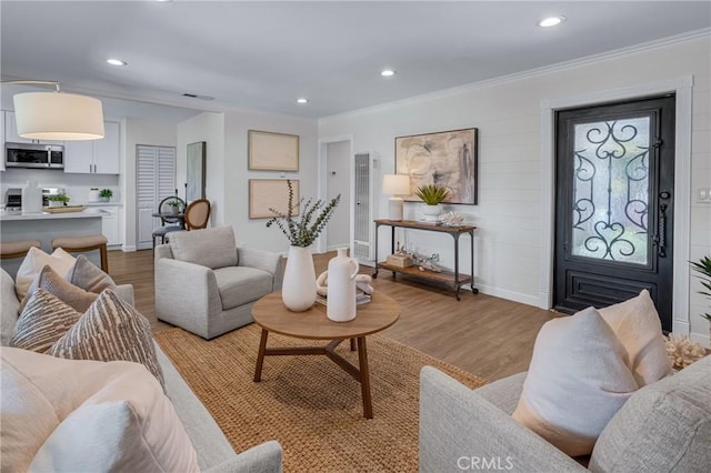3531 Josie Ave, Long Beach, CA 90808 - living area featuring a heating unit, light wood-style flooring, ornamental molding, and recessed lighting