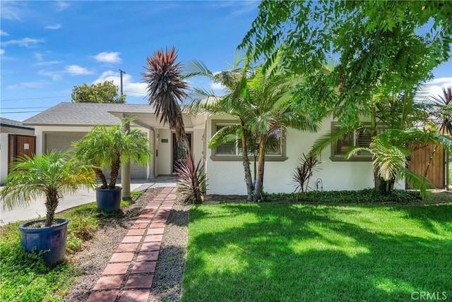 3531 Josie Ave, Long Beach, CA 90808 - view of front of property with stucco siding, a garage, a front lawn, and driveway