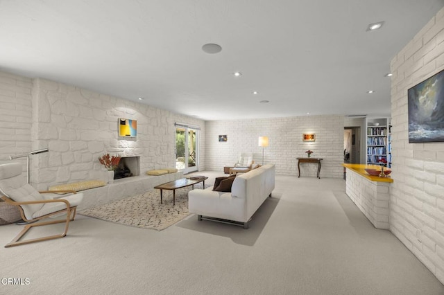 4530 Hendrickson Rd, Ojai, CA 93023 - living room featuring a stone fireplace, carpet, recessed lighting, and brick wall