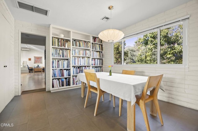 4530 Hendrickson Rd, Ojai, CA 93023 - dining space featuring an AC wall unit and dark tile patterned floors