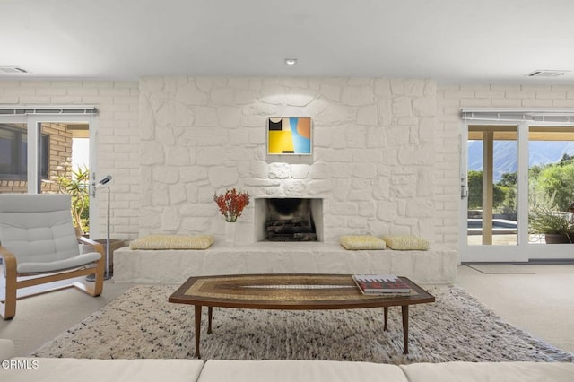 4530 Hendrickson Rd, Ojai, CA 93023 - living area with a stone fireplace, carpet, and healthy amount of natural light