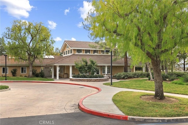 28403 Calex Dr, Valencia, CA 91354 - view of front of home featuring a tiled roof, a front yard, curved driveway, and solar panels