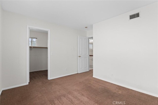 28403 Calex Dr, Valencia, CA 91354 - unfurnished bedroom featuring carpet flooring and a walk in closet