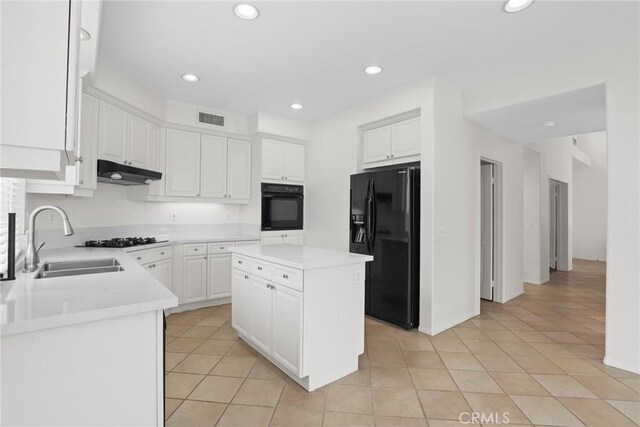 28403 Calex Dr, Valencia, CA 91354 - kitchen featuring black appliances, under cabinet range hood, light tile patterned floors, white cabinetry, and light countertops