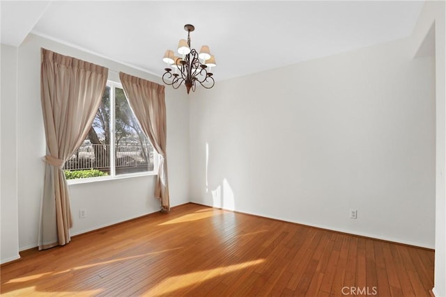 28403 Calex Dr, Valencia, CA 91354 - spare room featuring a chandelier and wood-type flooring