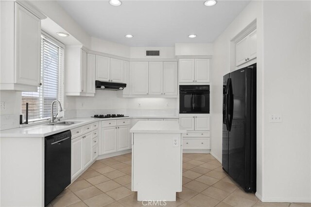28403 Calex Dr, Valencia, CA 91354 - kitchen with black appliances, under cabinet range hood, white cabinetry, light countertops, and a center island