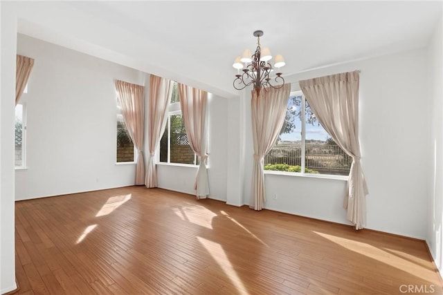 28403 Calex Dr, Valencia, CA 91354 - spare room with a chandelier and wood-type flooring