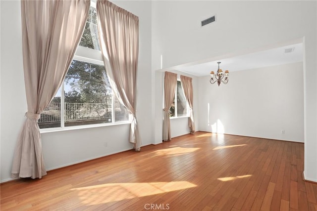 28403 Calex Dr, Valencia, CA 91354 - unfurnished living room featuring a chandelier and hardwood / wood-style flooring