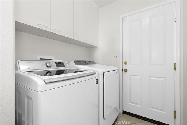 28403 Calex Dr, Valencia, CA 91354 - laundry room with cabinet space, washer and dryer, and light tile patterned floors