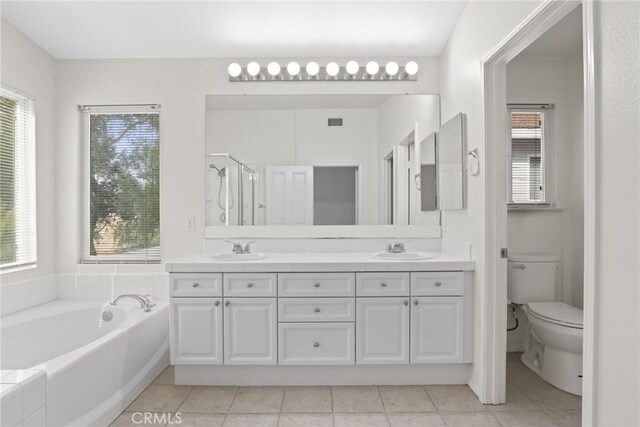 28403 Calex Dr, Valencia, CA 91354 - bathroom with double vanity, tile patterned flooring, a garden tub, and a shower stall