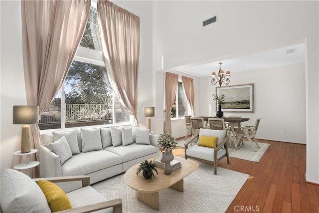 28403 Calex Dr, Valencia, CA 91354 - living room with a chandelier, a towering ceiling, and hardwood / wood-style floors