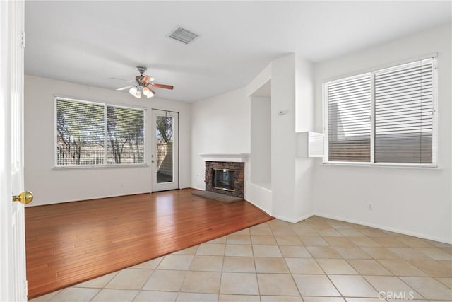 28403 Calex Dr, Valencia, CA 91354 - unfurnished living room featuring a ceiling fan, a glass covered fireplace, and light tile patterned floors