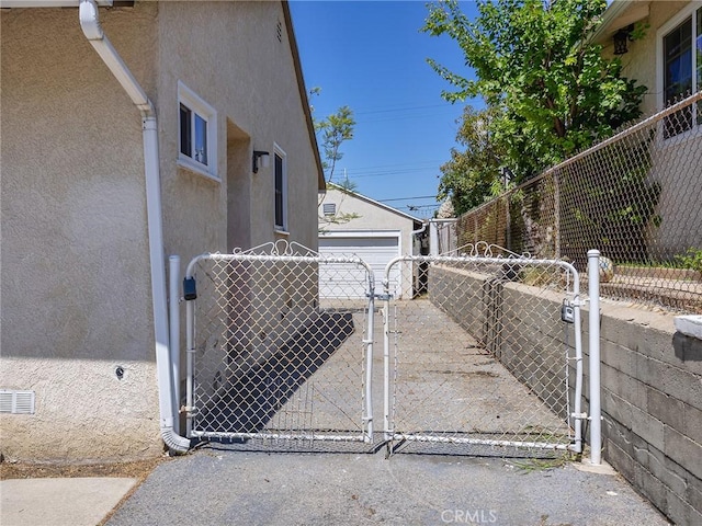 2623 N Parish Pl, Burbank, CA 91504 - view of home's exterior with stucco siding, an outbuilding, a gate, and a detached garage