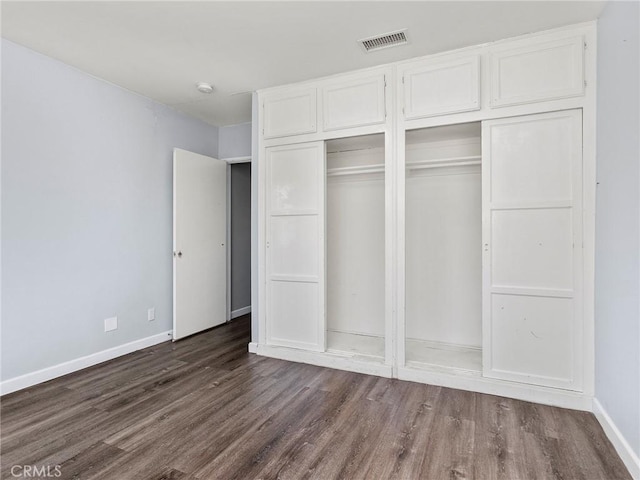 2623 N Parish Pl, Burbank, CA 91504 - unfurnished bedroom featuring dark wood-type flooring and baseboards