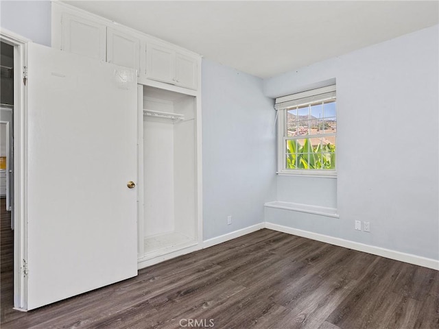 2623 N Parish Pl, Burbank, CA 91504 - unfurnished bedroom with dark wood-style flooring and a closet