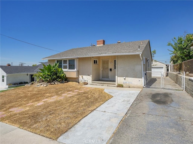 2623 N Parish Pl, Burbank, CA 91504 - view of front of house featuring a gate, a chimney, stucco siding, and roof with shingles