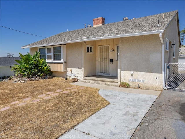 2623 N Parish Pl, Burbank, CA 91504 - view of front of home with a chimney, stucco siding, and roof with shingles