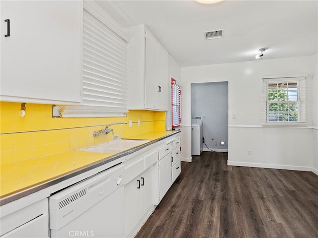 2623 N Parish Pl, Burbank, CA 91504 - kitchen with white dishwasher, white cabinets, dark wood-style flooring, and tasteful backsplash