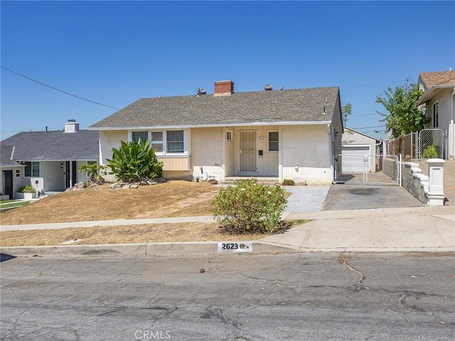 2623 N Parish Pl, Burbank, CA 91504 - ranch-style home featuring a gate, stucco siding, a chimney, concrete driveway, and roof with shingles