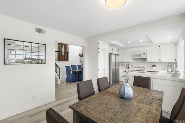 1471 Mercado, Escondido, CA 92026 - dining room with light wood-style floors, stairway, recessed lighting, and a tray ceiling
