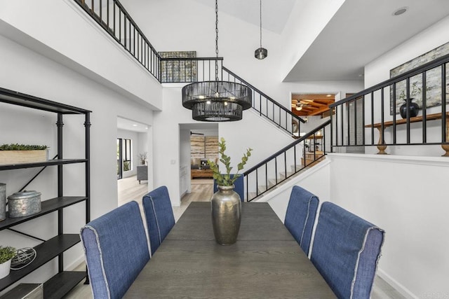 1471 Mercado, Escondido, CA 92026 - unfurnished dining area with a high ceiling, stairway, and wood finished floors