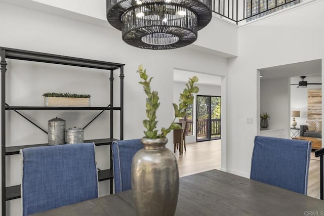 1471 Mercado, Escondido, CA 92026 - dining area with wood finished floors, a ceiling fan, a chandelier, and a high ceiling