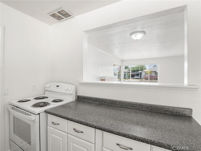 2135 Arden Dr W, Fresno, CA 93703 - kitchen with white electric stove, dark countertops, white cabinetry, and a textured ceiling