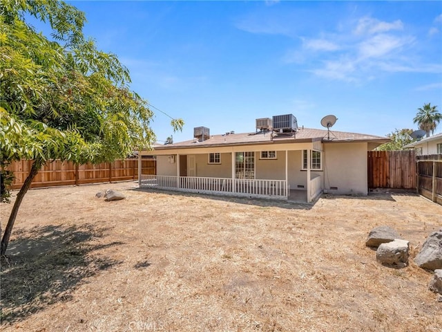 2135 Arden Dr W, Fresno, CA 93703 - back of house with a fenced backyard, stucco siding, a patio, and solar panels