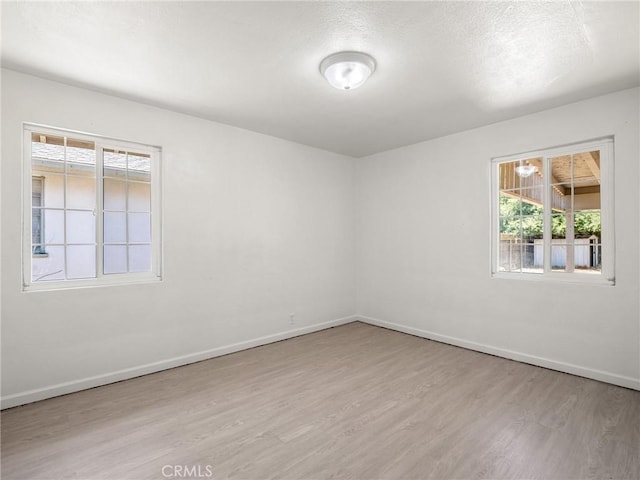 2135 Arden Dr W, Fresno, CA 93703 - spare room with wood finished floors and baseboards