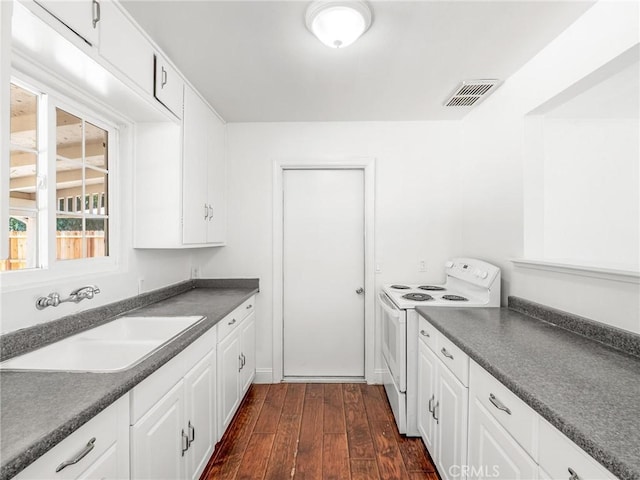 2135 Arden Dr W, Fresno, CA 93703 - kitchen featuring white range with electric stovetop, dark countertops, white cabinetry, and dark wood-style floors