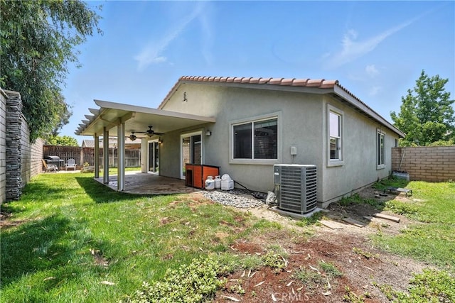 23885 Cheyenne Canyon Dr, Menifee, CA 92587 - back of property with a ceiling fan, a fenced backyard, a patio area, and stucco siding
