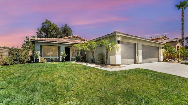 23885 Cheyenne Canyon Dr, Menifee, CA 92587 - view of front of home with stucco siding, an attached garage, driveway, a yard, and a tiled roof