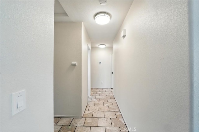 23885 Cheyenne Canyon Dr, Menifee, CA 92587 - hallway featuring baseboards and a textured wall