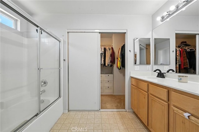 23885 Cheyenne Canyon Dr, Menifee, CA 92587 - bathroom with vanity, shower / bath combination with glass door, a spacious closet, and tile patterned floors