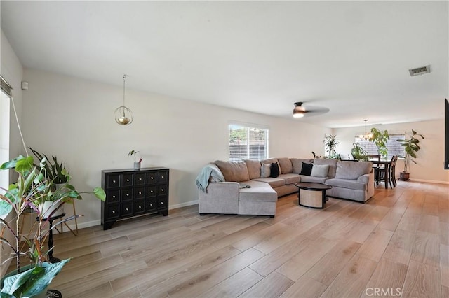 23885 Cheyenne Canyon Dr, Menifee, CA 92587 - living room with light wood-type flooring and a chandelier