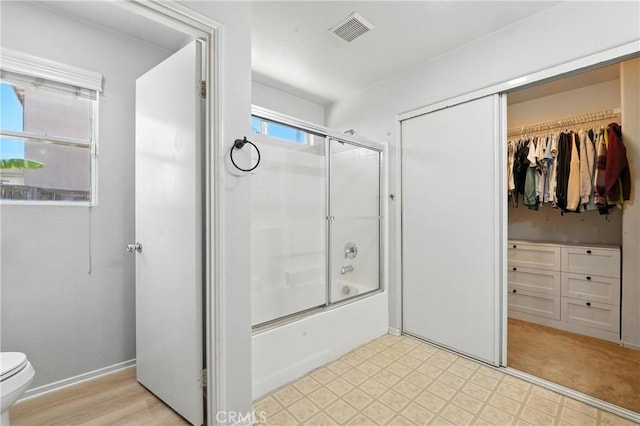 23885 Cheyenne Canyon Dr, Menifee, CA 92587 - bathroom with enclosed tub / shower combo, tile patterned floors, and a walk in closet