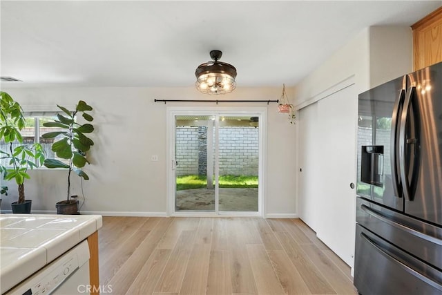 23885 Cheyenne Canyon Dr, Menifee, CA 92587 - unfurnished dining area featuring light wood finished floors and healthy amount of natural light