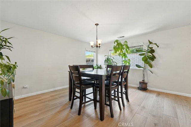 23885 Cheyenne Canyon Dr, Menifee, CA 92587 - dining space featuring a chandelier and light wood-type flooring