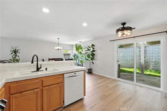 23885 Cheyenne Canyon Dr, Menifee, CA 92587 - kitchen featuring white dishwasher, a chandelier, tile countertops, light wood finished floors, and recessed lighting