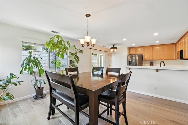 23885 Cheyenne Canyon Dr, Menifee, CA 92587 - dining room with healthy amount of natural light, a chandelier, recessed lighting, and light wood-style floors