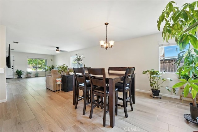 23885 Cheyenne Canyon Dr, Menifee, CA 92587 - dining space with light wood-type flooring, a chandelier, and ceiling fan