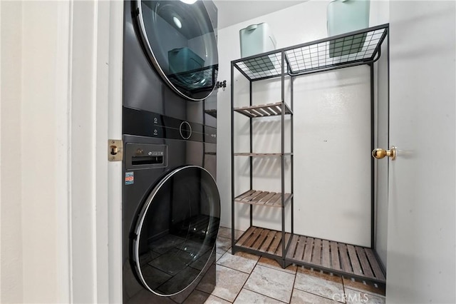 23885 Cheyenne Canyon Dr, Menifee, CA 92587 - washroom featuring stacked washing machine and dryer and light tile patterned flooring